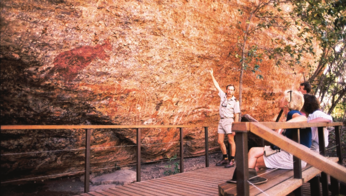 People learning about history from a park ranger at an Australian archaeological site